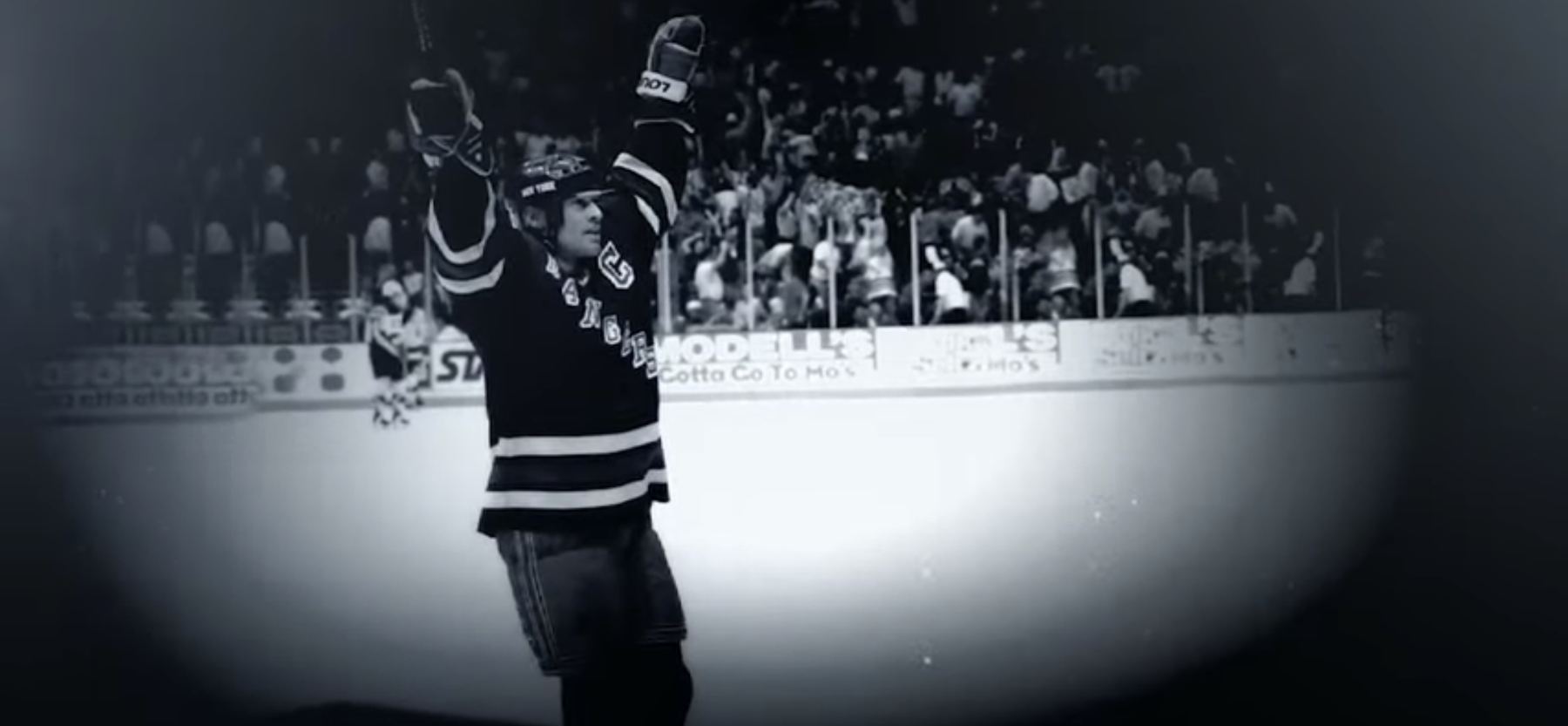 Mark Messier in a Rangers jersey, both arms raised in celebration